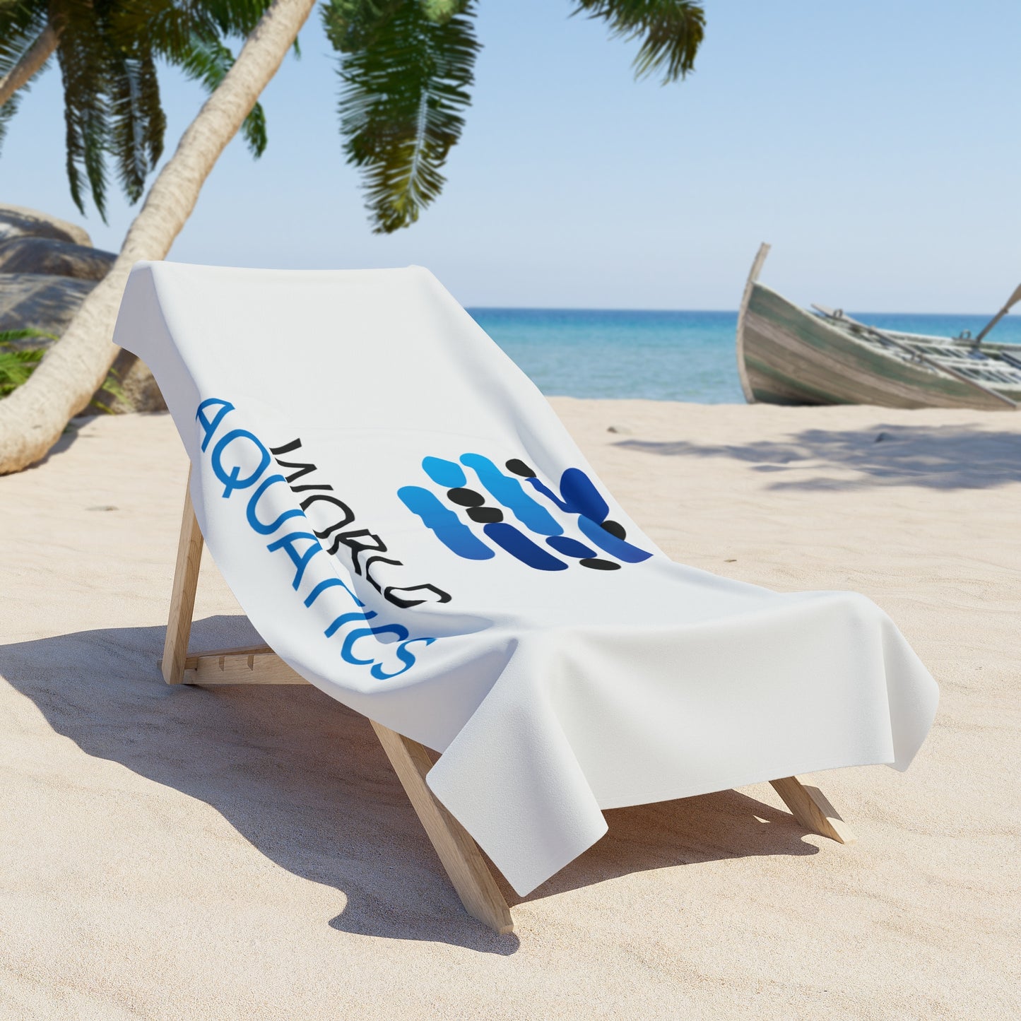 Beach chair with a towel featuring 'Worlds Aquatics' on a sandy beach with palm trees and ocean in the background.