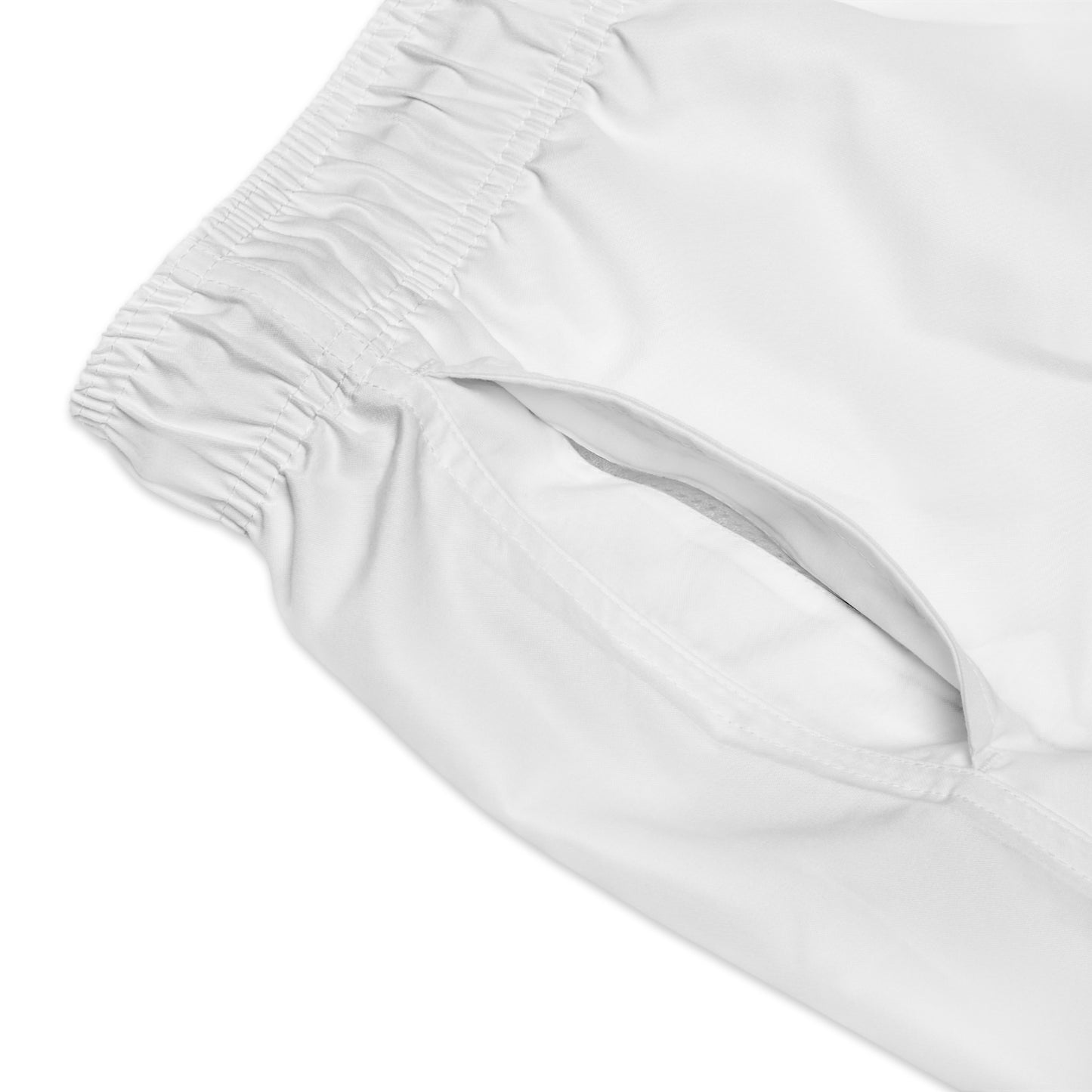 Man wearing World Aquatics Men’s Swim Trunks at the beach – vibrant design, quick-dry fabric and effortless summer style.