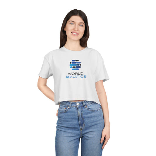 Woman wearing World Aquatics Women’s Cropped T-Shirt – relaxed fit crop top with logo, perfect for casual summer looks.